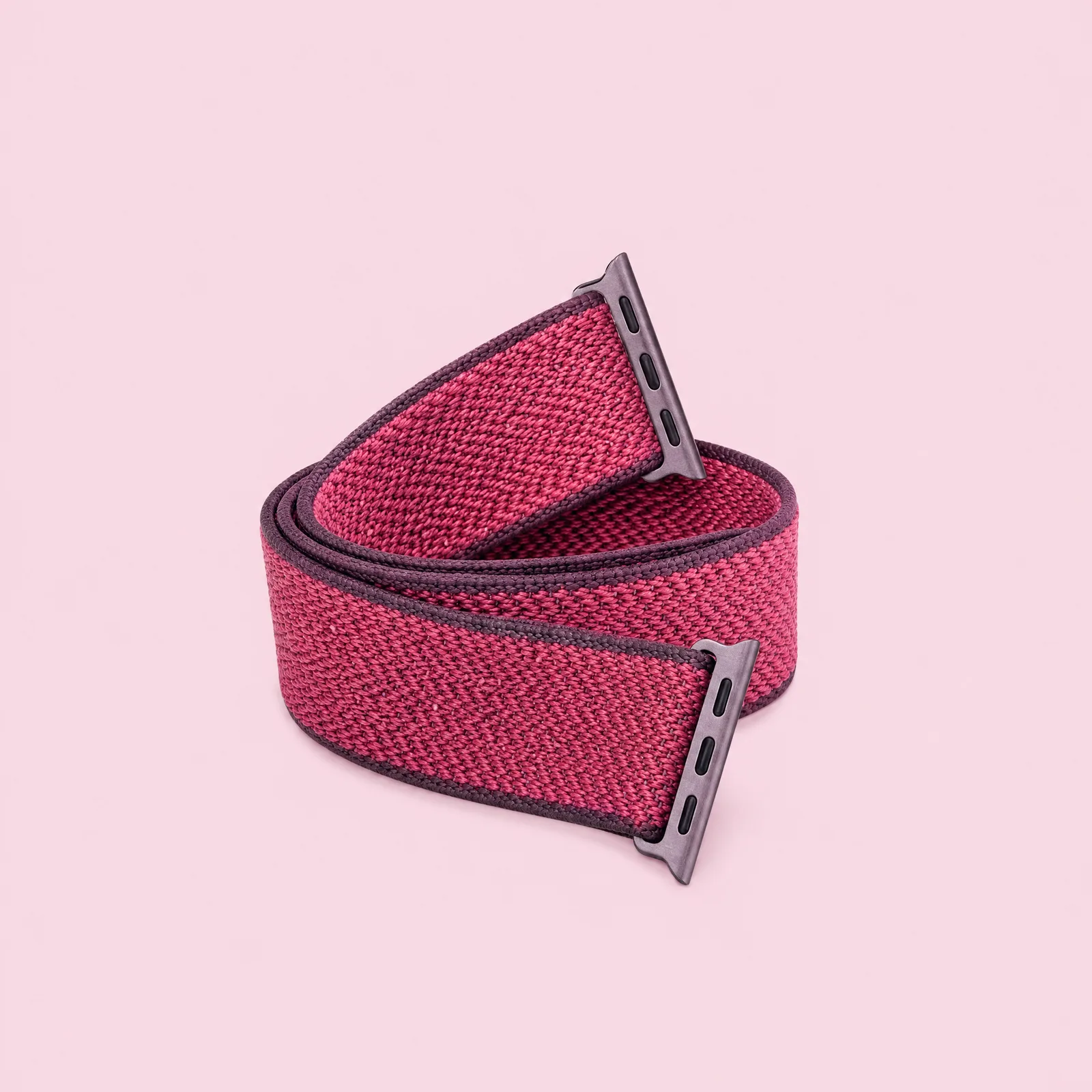 A woven fabric watch strap curled into a coil